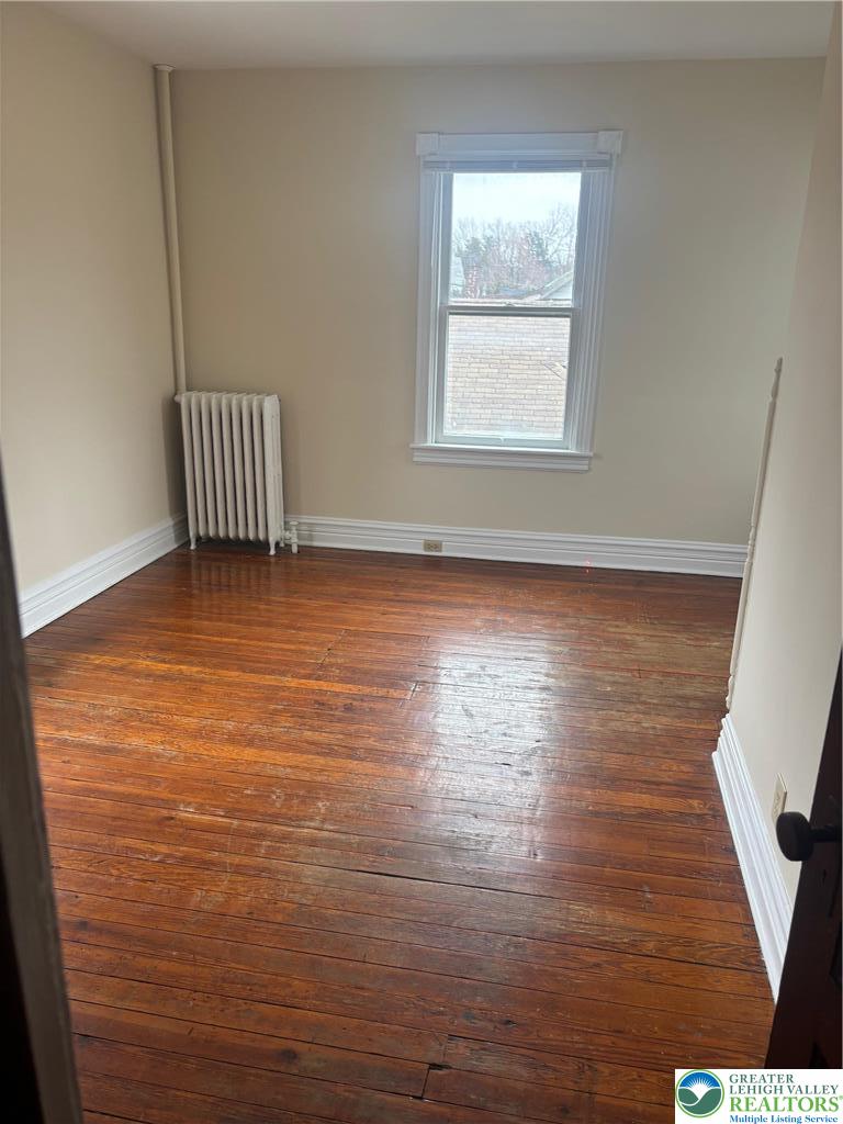 3629 Dorney Road Allentown, PA 18104 - Photo 8 of 8 a view of an empty room with wooden floor and a window