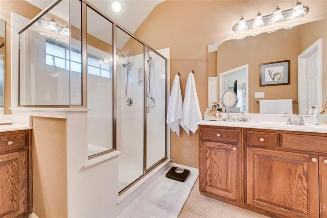 a bathroom with a double vanity sink and mirror