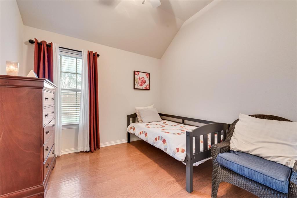101 Cassandra Drive Forney, TX 75126 - Photo 16 of 21 a bedroom with a bed and a window