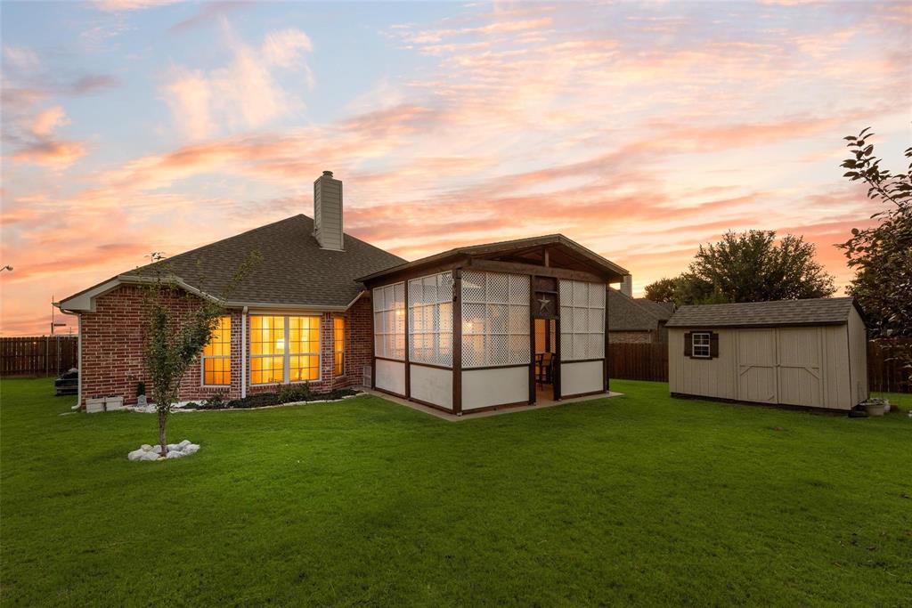 101 Cassandra Drive Forney, TX 75126 - Photo 20 of 21 a front view of a house with a garden and yard