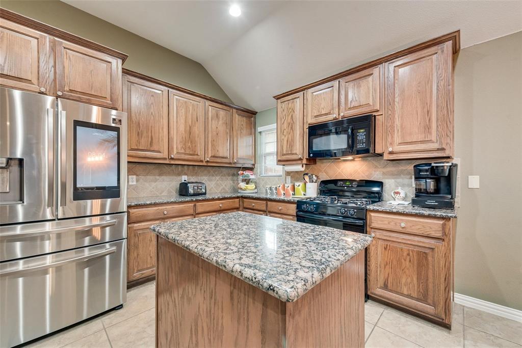 101 Cassandra Drive Forney, TX 75126 - Photo 5 of 21 a kitchen with stainless steel appliances granite countertop a refrigerator stove microwave and sink