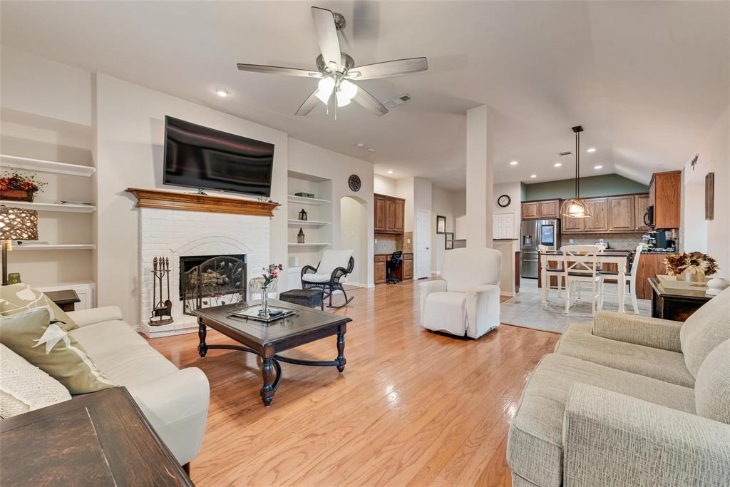 101 Cassandra Drive Forney, TX 75126 - Photo 8 of 21 a living room with furniture and a fireplace