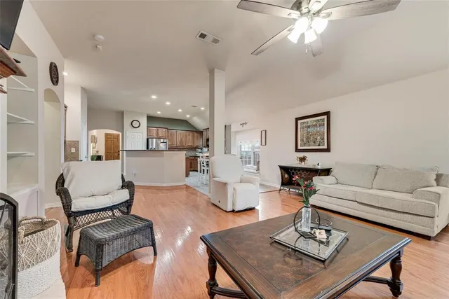 a living room with furniture and a view of kitchen