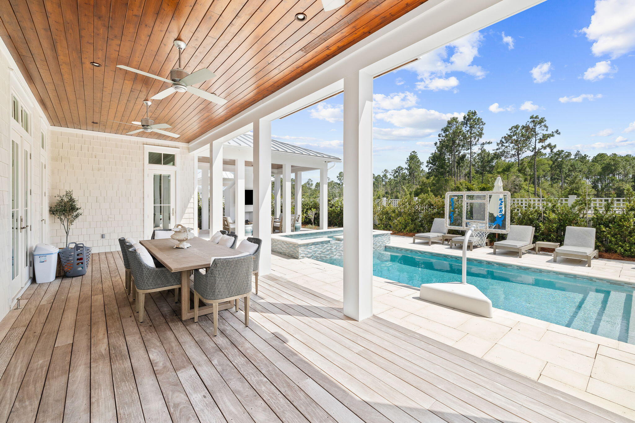 12 Needle Cast Ln Inlet Beach Inlet Beach, FL 32461 - Photo 58 of 74 a view of a patio with table and chairs and floor to ceiling window with wooden floor
