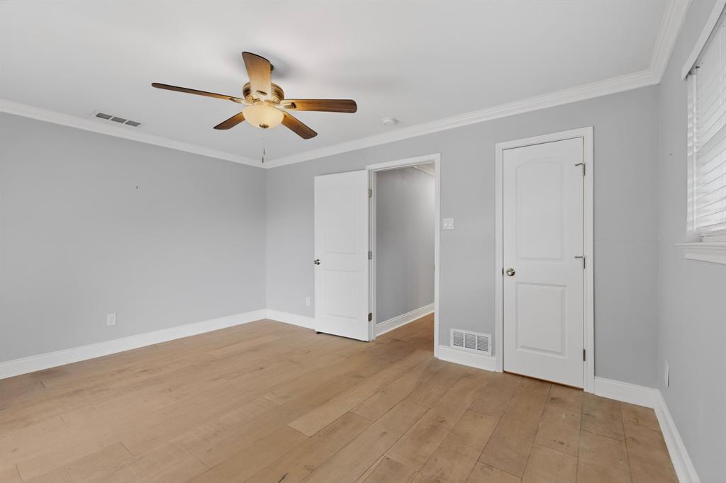 7631 Meadow Road Dallas, TX 75230 - Photo 27 of 40 A bright bedroom with a ceiling fan and a closet
