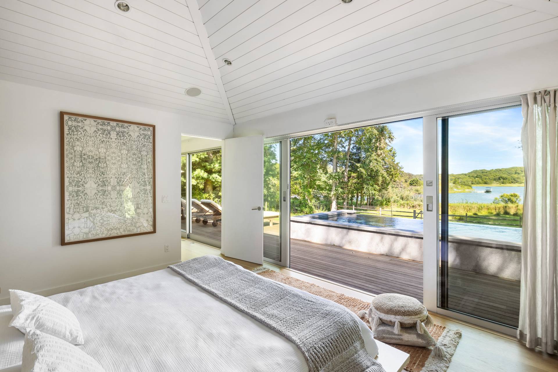 26 Oyster Shores Road East Hampton, NY 11937 - Photo 11 of 17 a bedroom with a large window and a bed