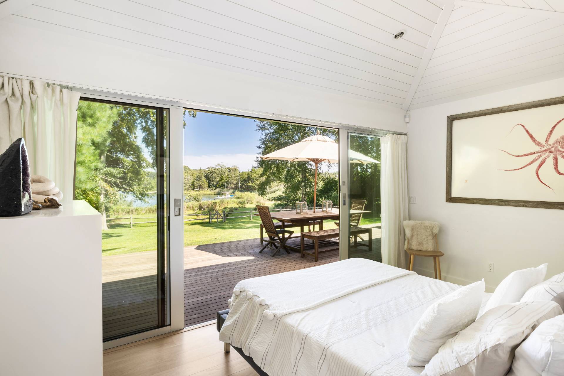 26 Oyster Shores Road East Hampton, NY 11937 - Photo 14 of 17 a bedroom with a bed and large windows