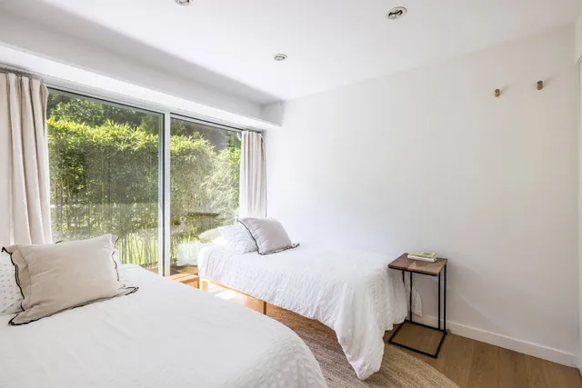 a bedroom with a bed and a lamp next to a window