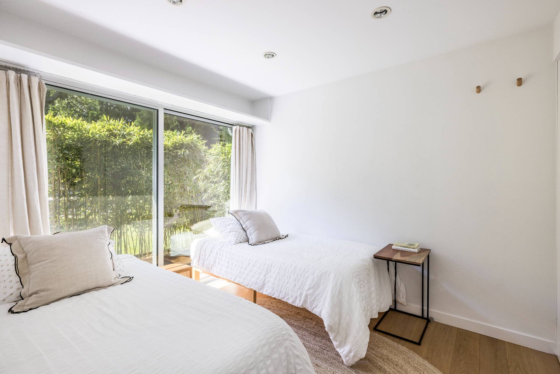 26 Oyster Shores Road East Hampton, NY 11937 - Photo 16 of 17 a bedroom with a bed and a lamp next to a window