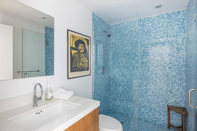 a bathroom with a sink a toilet and mirror