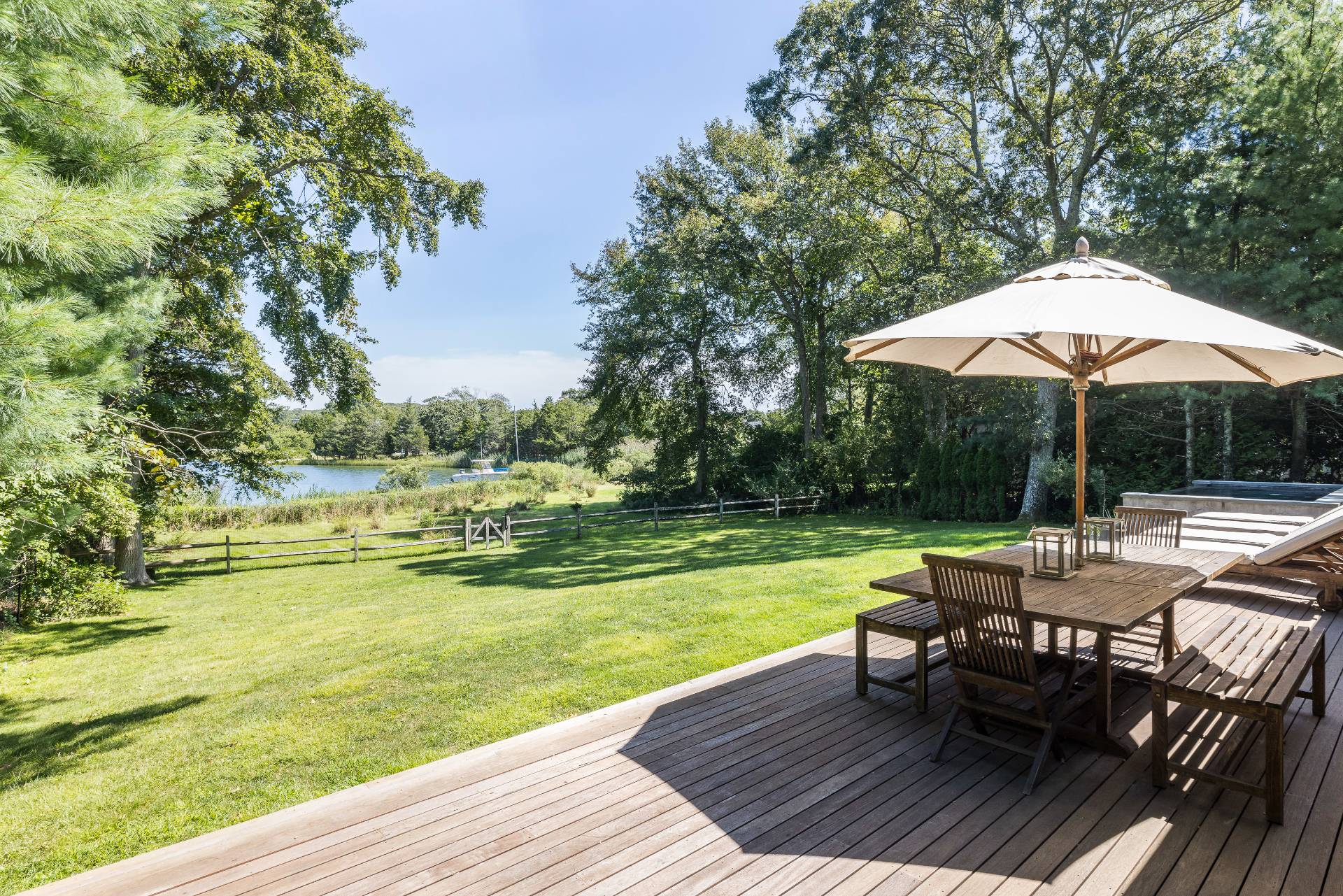 26 Oyster Shores Road East Hampton, NY 11937 - Photo 3 of 17 an outdoor space with furniture and umbrella