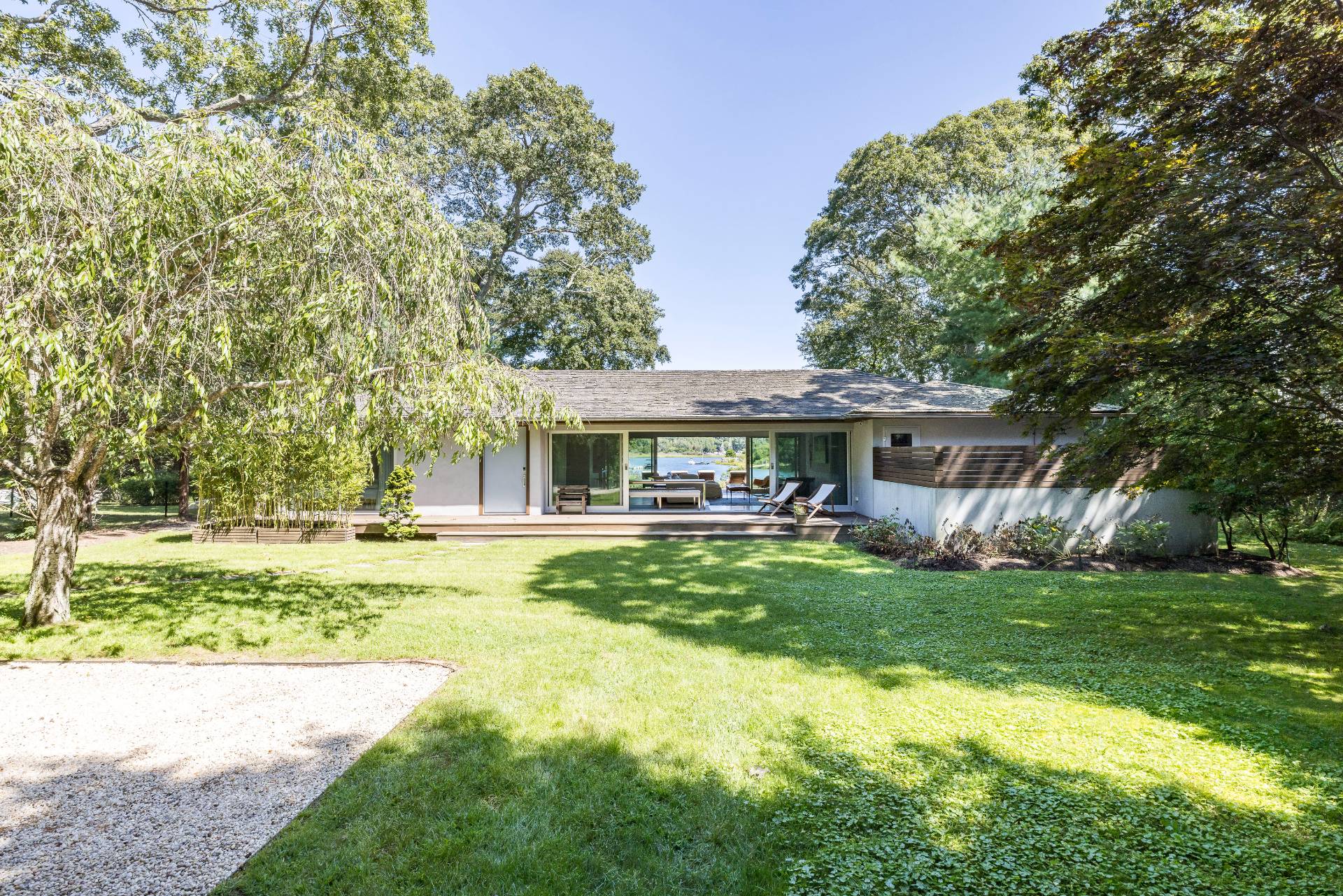26 Oyster Shores Road East Hampton, NY 11937 - Photo 5 of 17 a front view of house with yard and seating area