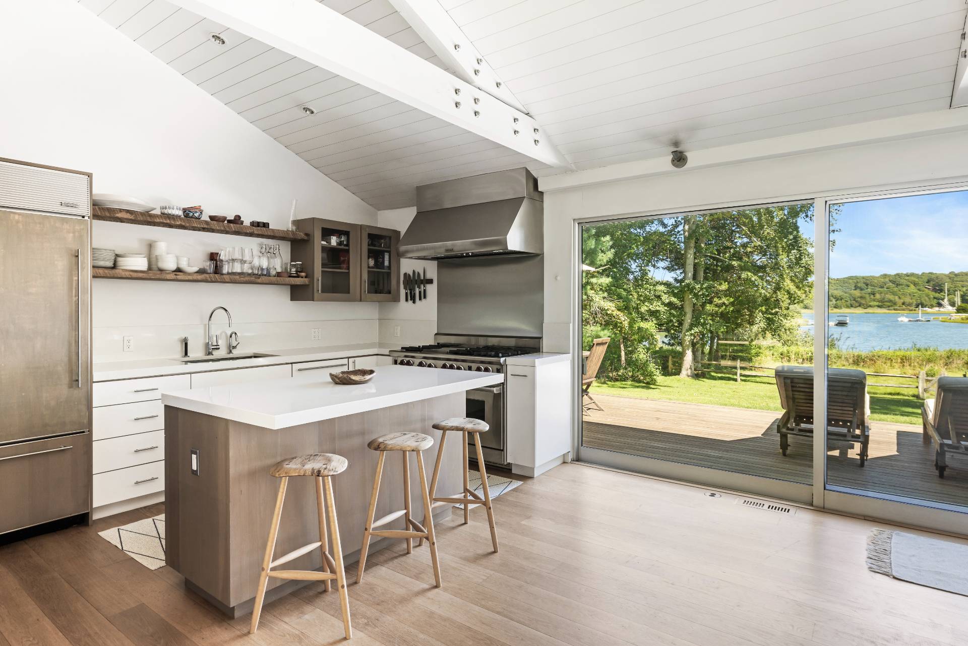 26 Oyster Shores Road East Hampton, NY 11937 - Photo 8 of 17 a kitchen that has a sink a stove and chairs