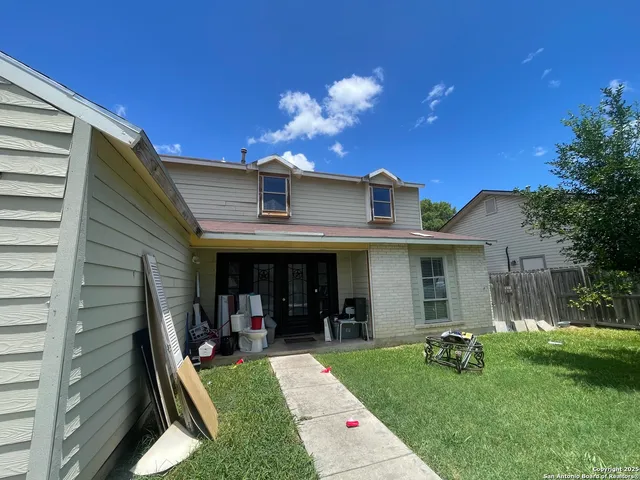 a view of a house with backyard porch and sitting area