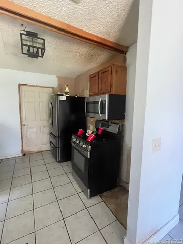 a living room with furniture a dining table and chairs with wooden floor