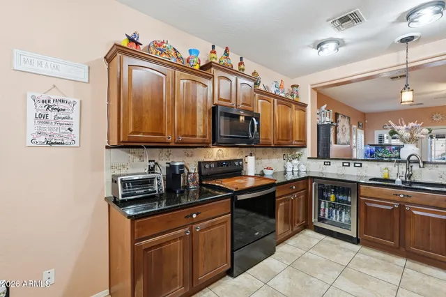 a kitchen with stainless steel appliances granite countertop a sink and dishwasher a stove top oven with wooden floor
