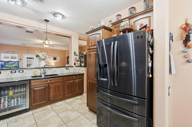 a kitchen with stainless steel appliances granite countertop a refrigerator and a sink