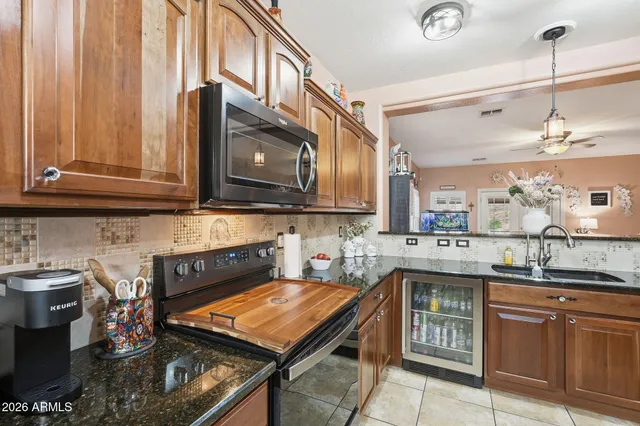 a kitchen with stainless steel appliances granite countertop a stove a sink and a microwave