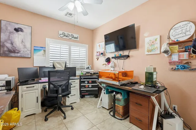 a view of a workspace with furniture and a flat screen tv
