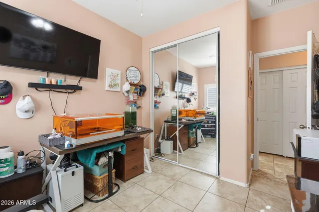 a room with furniture a flat screen tv and chairs