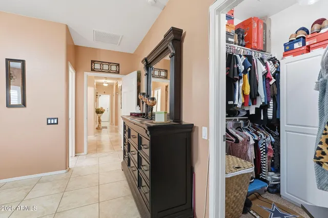 a view of a hallway with a view of bedroom and utility room