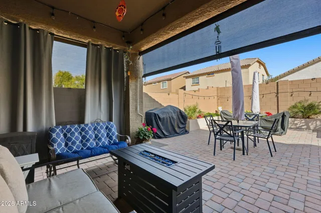a view of a patio with a table and chairs