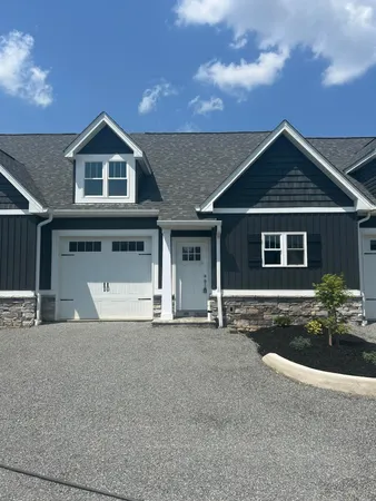 a front view of a house with yard