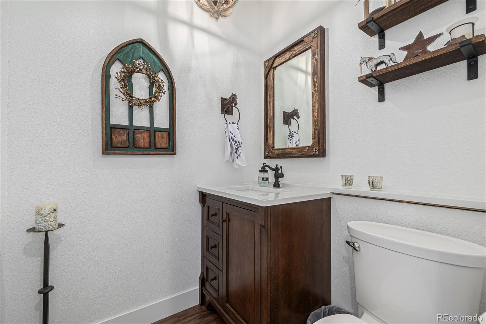 663 Brookside Drive Bailey, CO 80421 - Photo 22 of 47 a bathroom with a toilet a sink and mirror