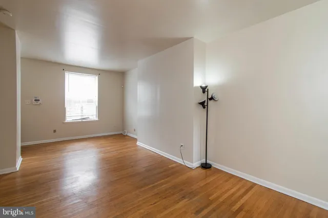 a view of a room with wooden floor and a sink