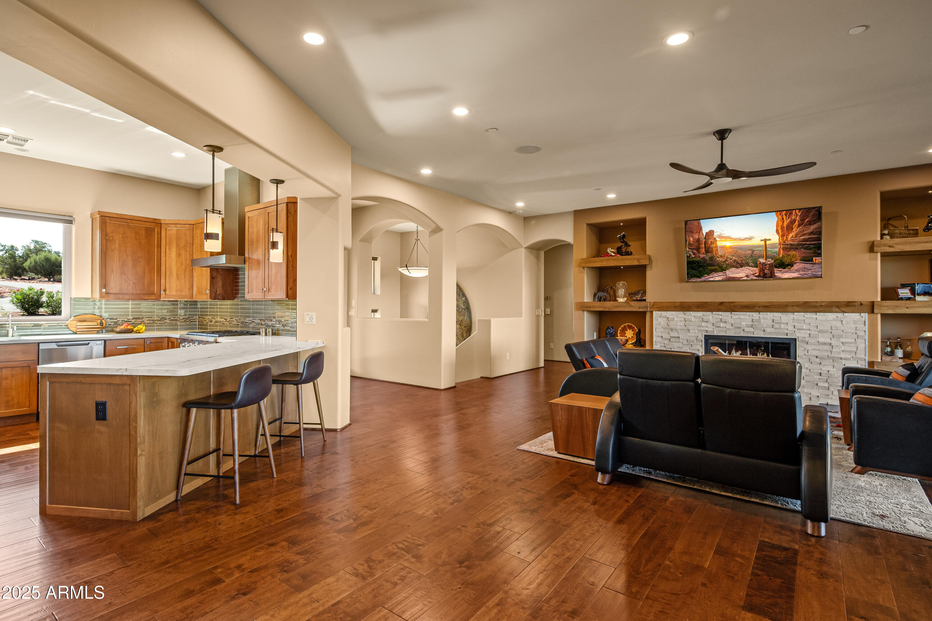150 Rimstone Circle Sedona, AZ 86336 - Photo 14 of 38 a living room with furniture a flat screen tv and wooden floor