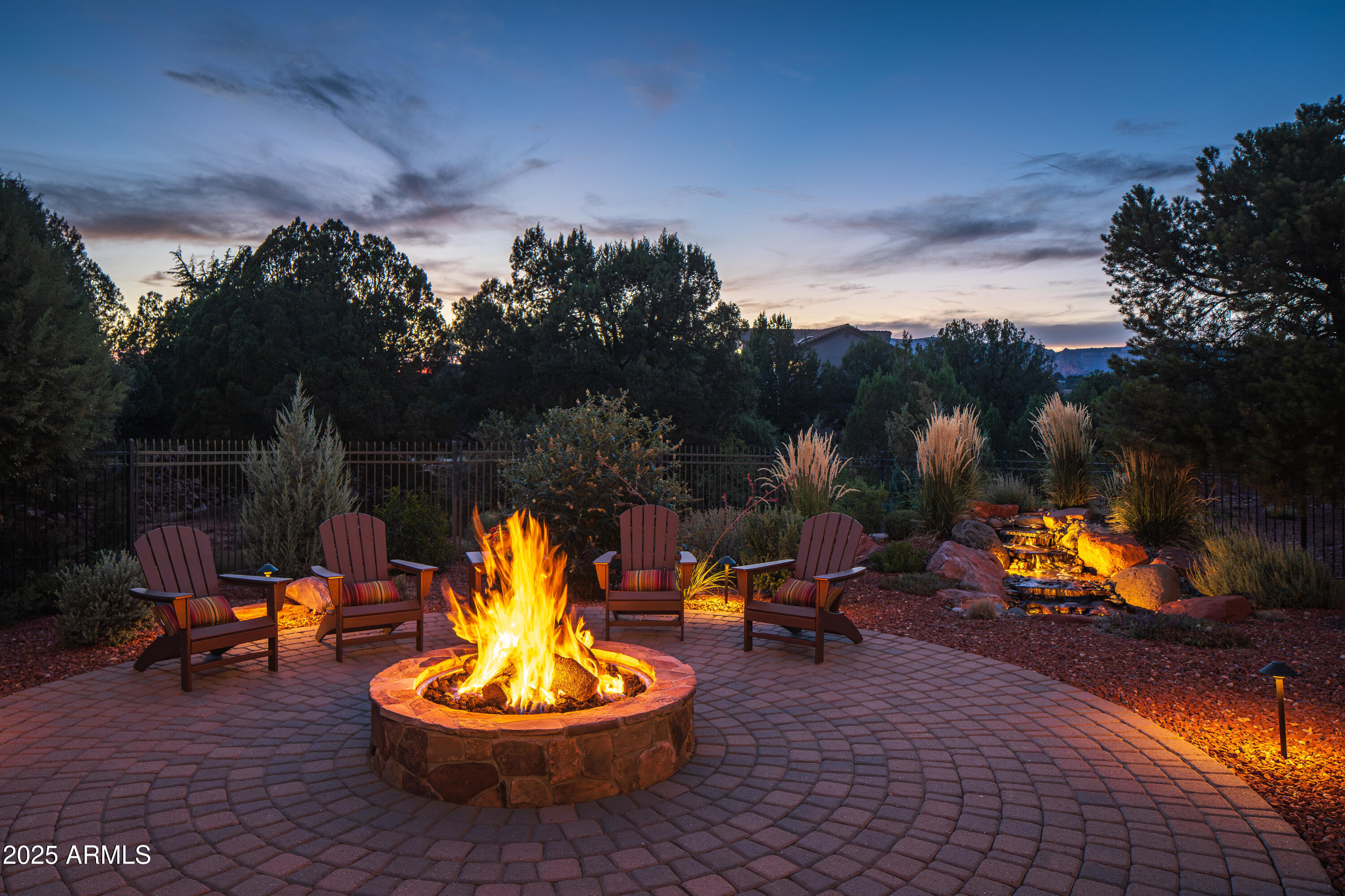 150 Rimstone Circle Sedona, AZ 86336 - Photo 35 of 38 a backyard of a house with fire pit and outdoor seating
