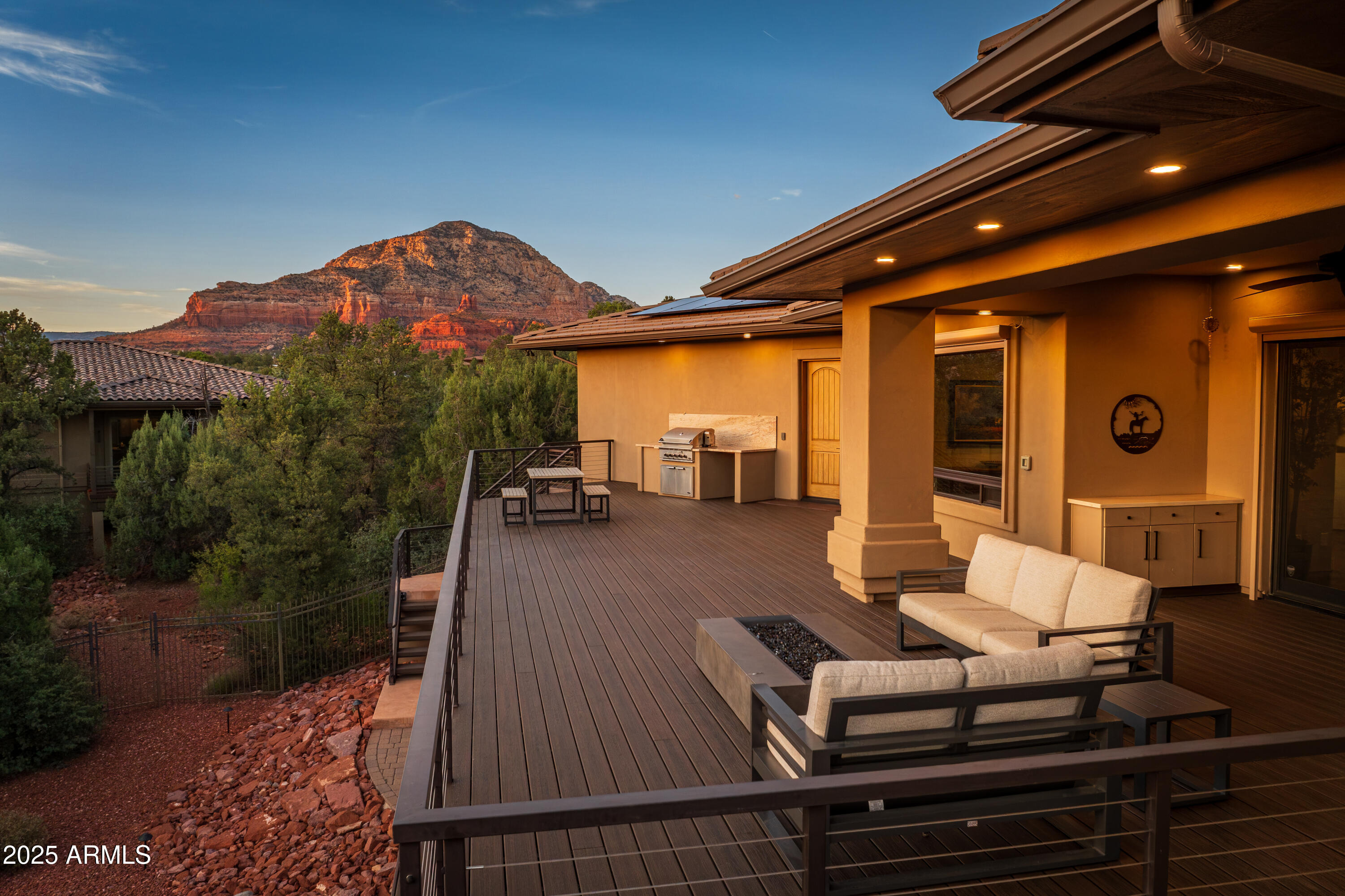 150 Rimstone Circle Sedona, AZ 86336 - Photo 37 of 38 a view of a patio with couches table and chairs with wooden floor