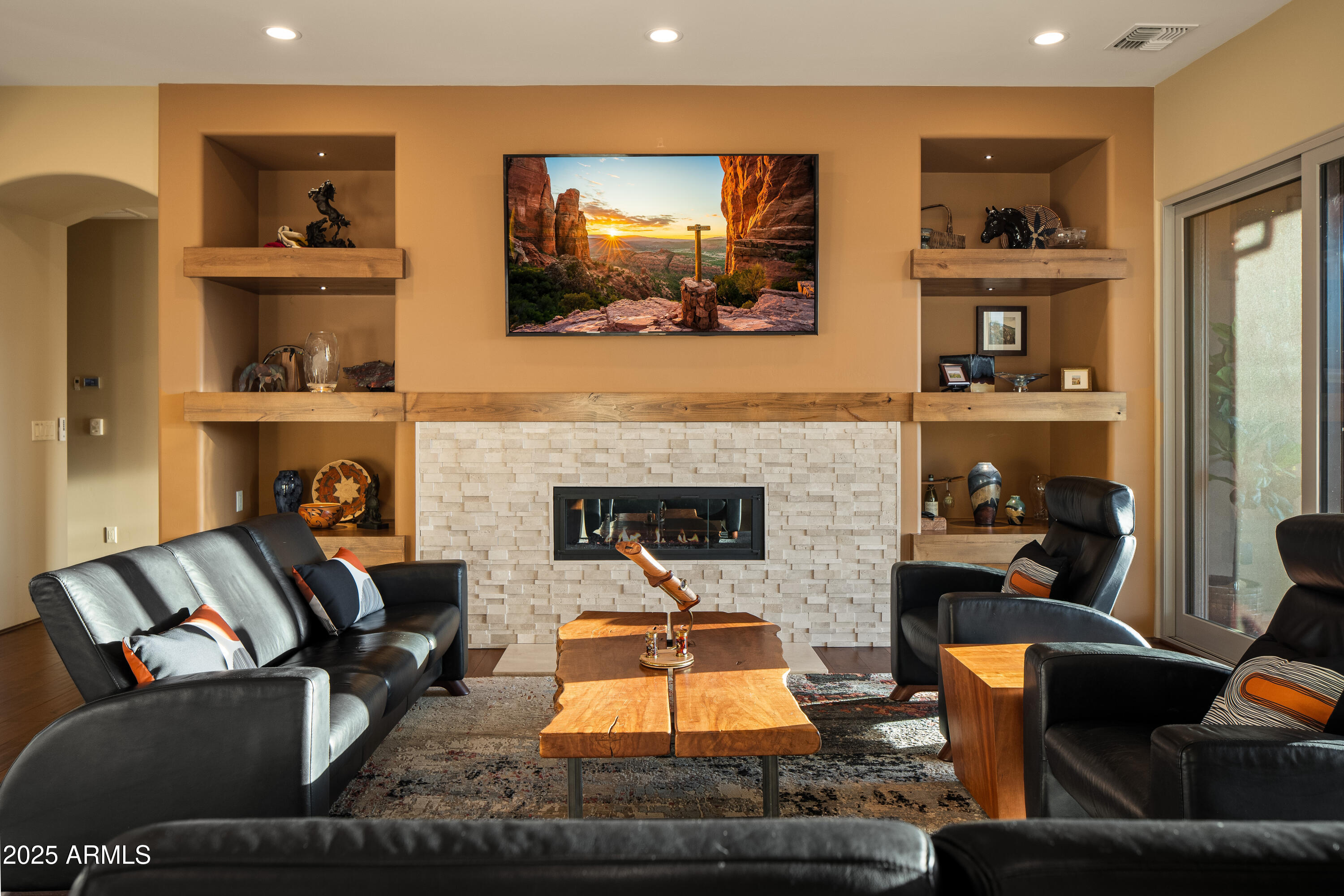 150 Rimstone Circle Sedona, AZ 86336 - Photo 8 of 38 a living room with furniture and a fireplace