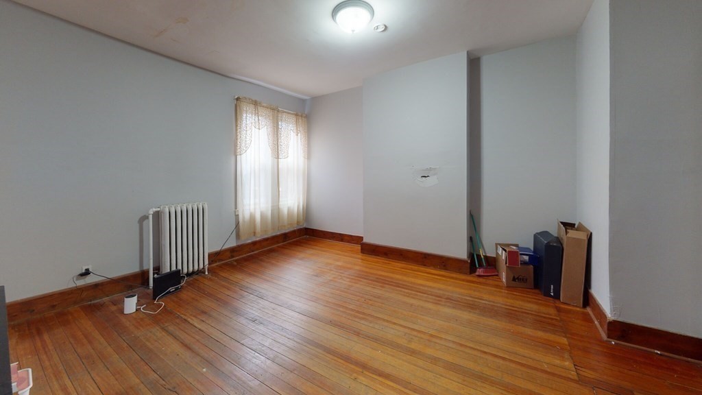 11 Forbes Street, Unit 2 Boston, MA 02130 - Photo 3 of 17 a view of empty room with wooden floor and fan
