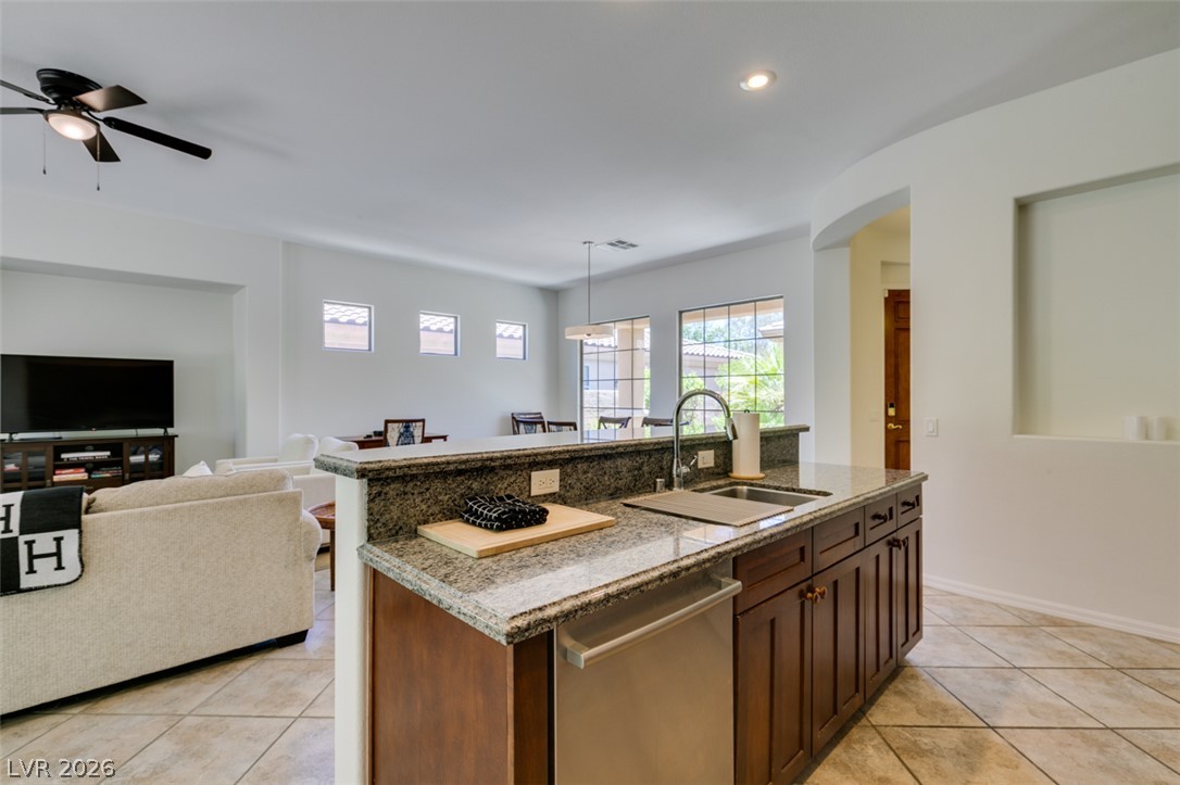 8 Kennesaw Road Henderson, NV 89052 - Photo 26 of 44 A sleek kitchen island with an integrated sink seamlessly connects to the inviting living area.