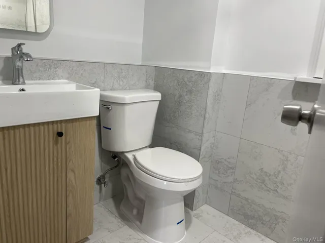 a bathroom with a sink a toilet and a mirror