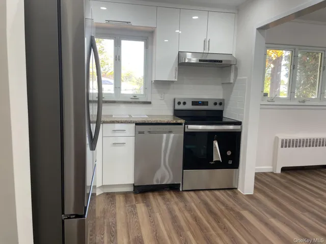 a kitchen with a stove and a wooden floors