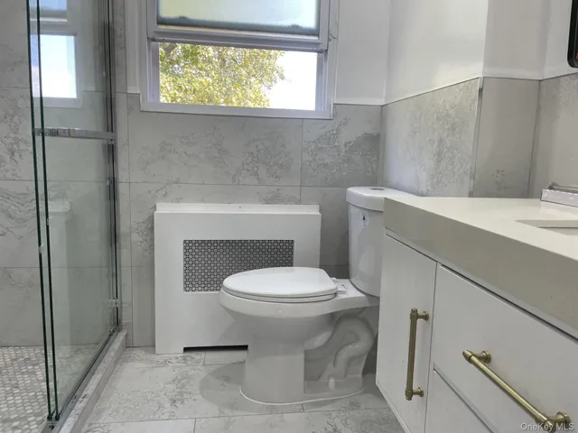 a bathroom with a toilet sink and vanity
