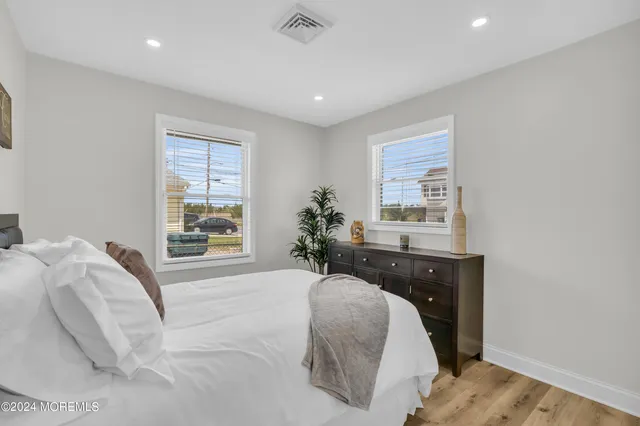 a spacious bedroom with a bed and a window