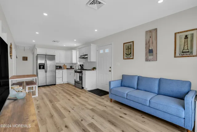 a living room with furniture and kitchen view