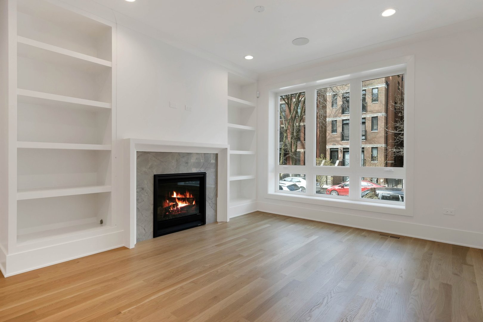 909 West Fletcher Street, Unit 1 Chicago, IL 60657 - Photo 12 of 22 a view of an empty room with a window and fireplace