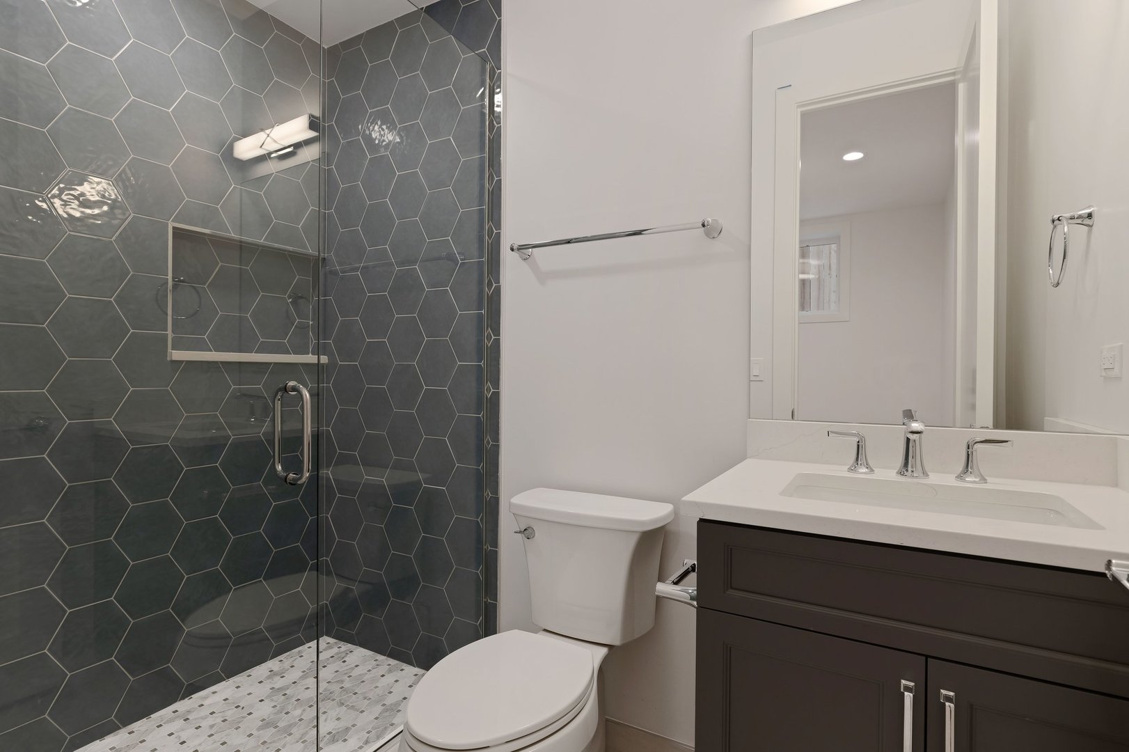 909 West Fletcher Street, Unit 1 Chicago, IL 60657 - Photo 19 of 22 a bathroom with a sink a toilet and shower