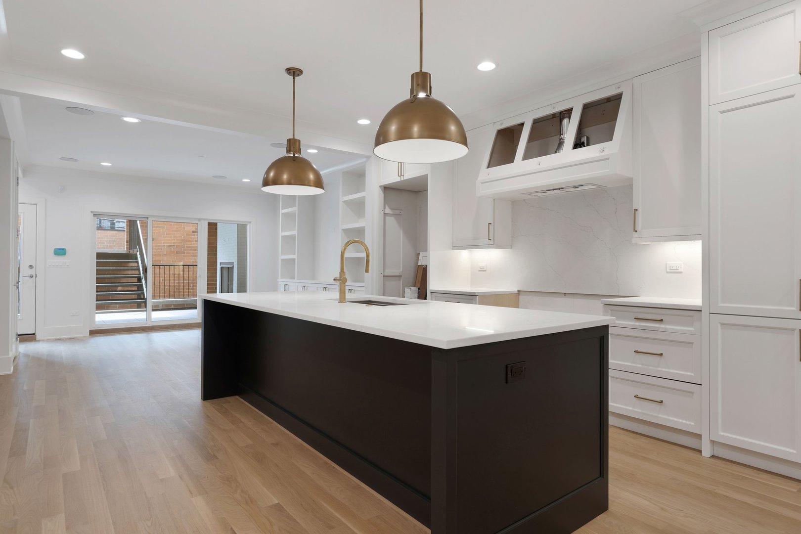 909 West Fletcher Street, Unit 1 Chicago, IL 60657 - Photo 2 of 22 a kitchen with kitchen island granite countertop a sink a counter space and stainless steel appliances