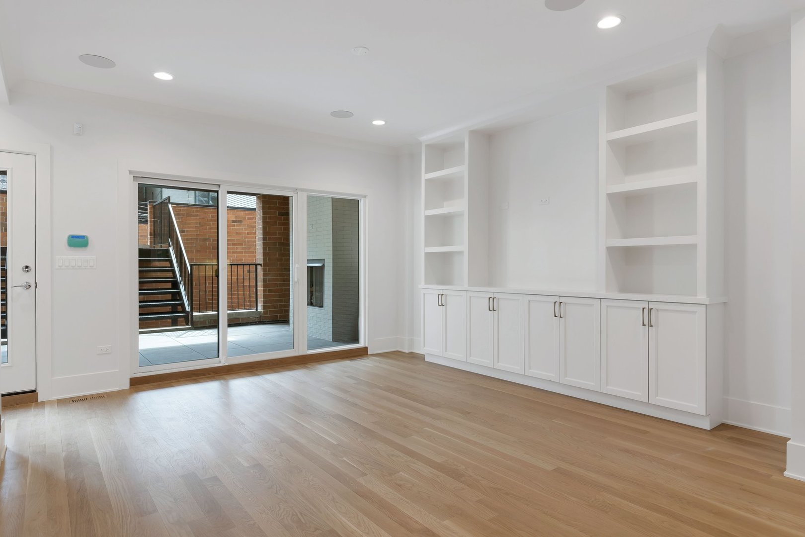 909 West Fletcher Street, Unit 1 Chicago, IL 60657 - Photo 5 of 22 an empty room with wooden floor and windows