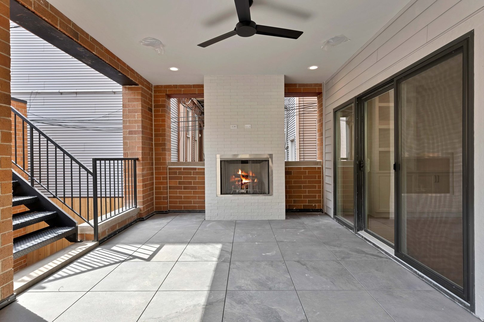 909 West Fletcher Street, Unit 1 Chicago, IL 60657 - Photo 7 of 22 a view of an empty room with a fireplace and a window