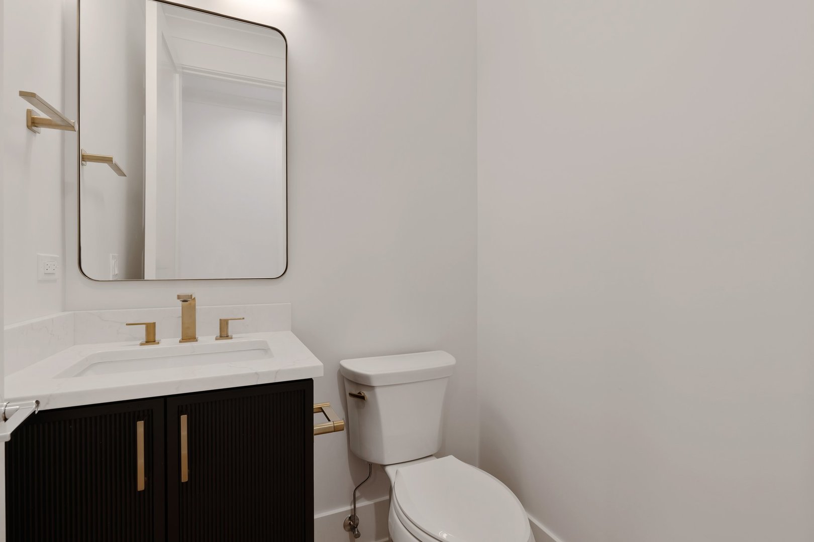 909 West Fletcher Street, Unit 1 Chicago, IL 60657 - Photo 8 of 22 a bathroom with a toilet sink vanity and mirror