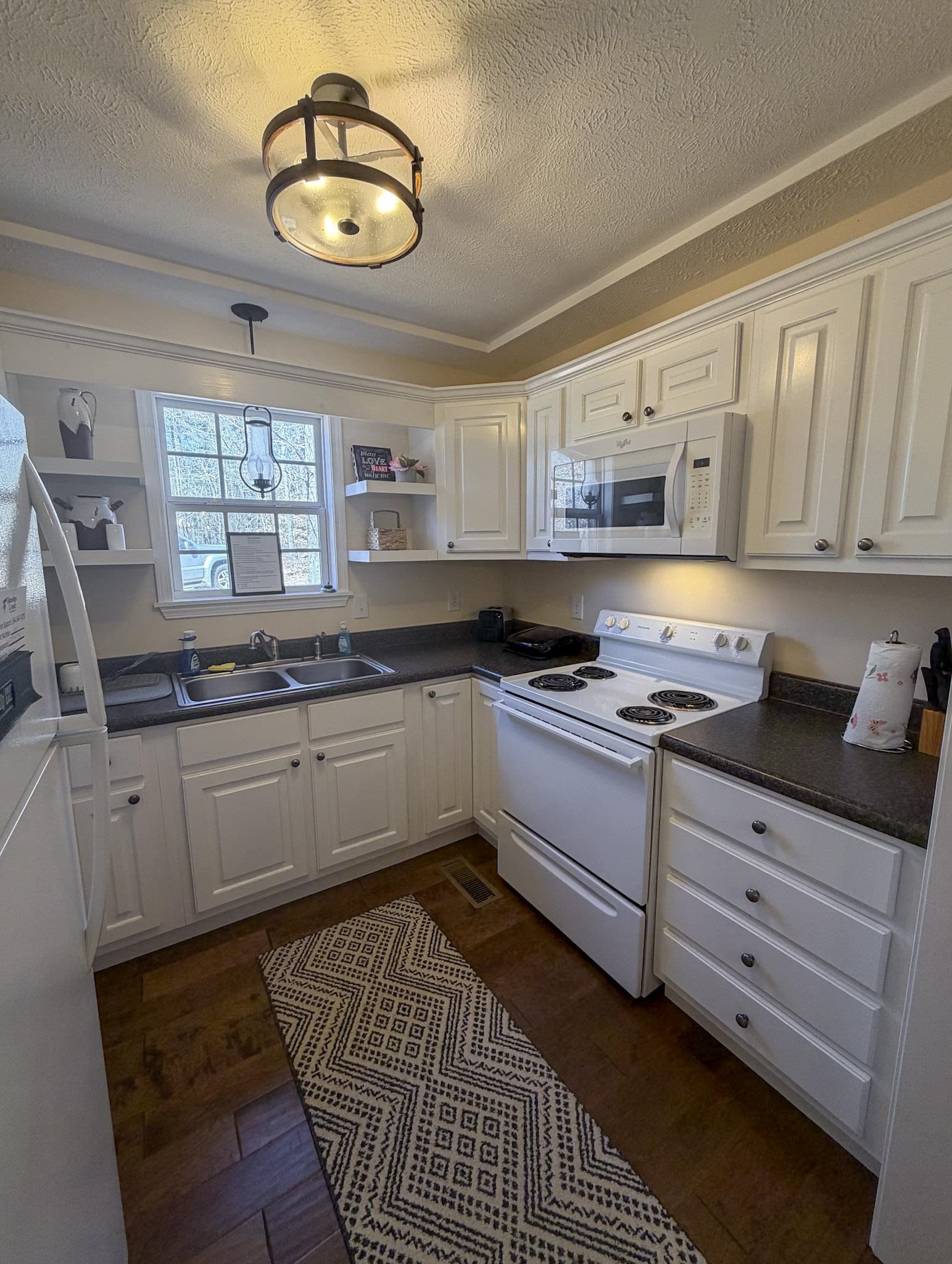 370 Cr 321 Road Iuka, MS 38852 - Photo 13 of 15 a kitchen with stainless steel appliances granite countertop a stove a sink and a white cabinets