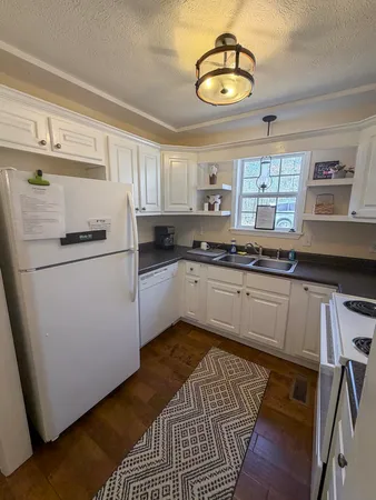 a kitchen with a sink cabinets and window