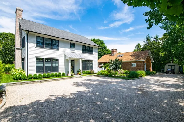a front view of a house with a garden
