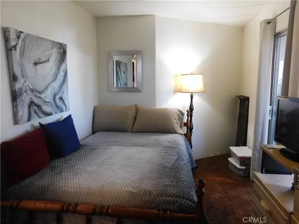 a bedroom with bed and a chandelier
